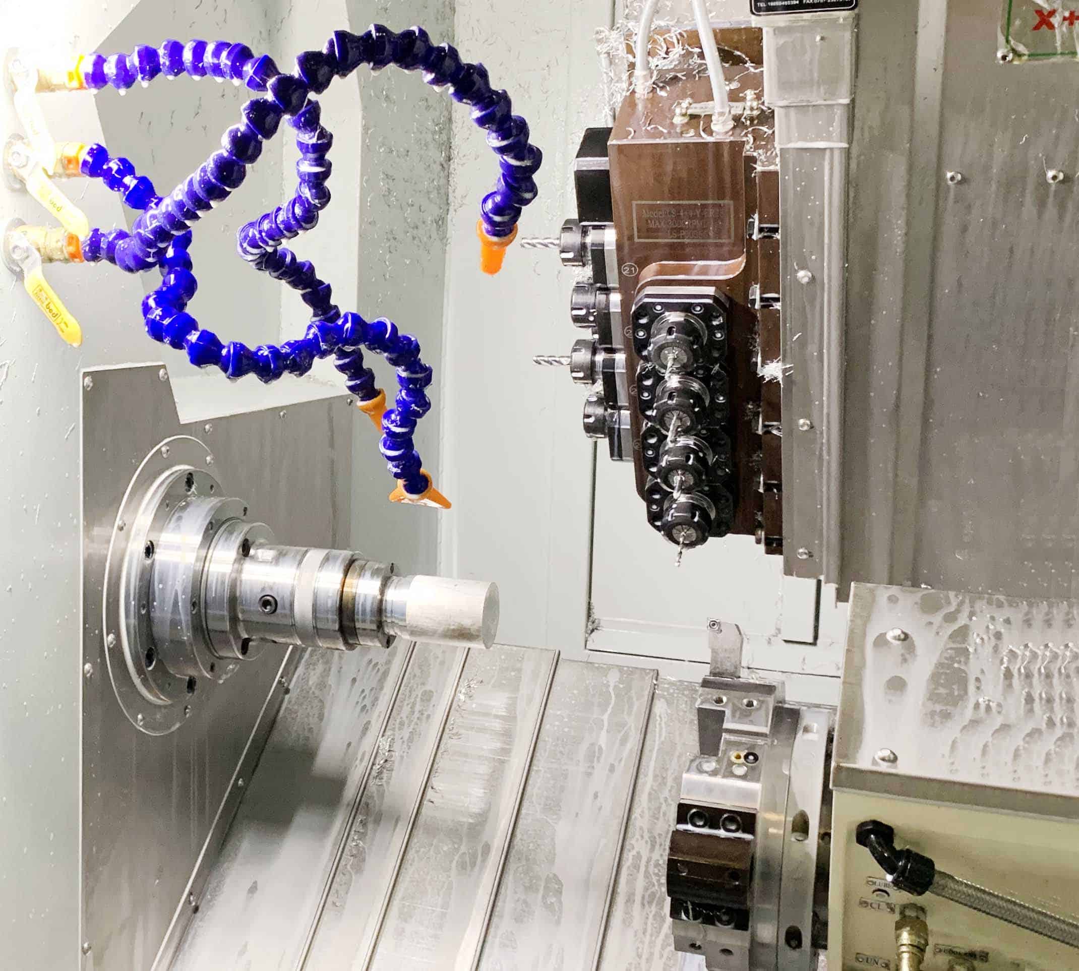 Close-up of a CNC turning machine processing a metal workpiece, showcasing precision cutting in mechanical machining industry