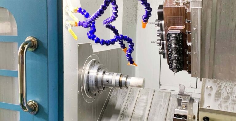 Close-up of CNC turning operation showing precision metal machining on lathe, explaining what is CNC turning and its industrial manufacturing applications