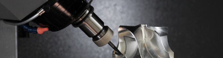 5-axis CNC machine performing precision machining, ideal for complex parts in aerospace and automotive manufacturing. Explains what is a 5 axis CNC machine and its industrial applications.