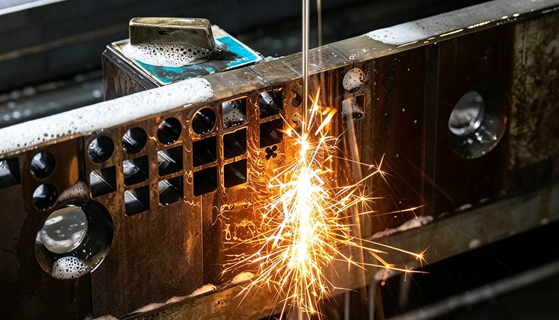 Wire EDM machining precision metal workpiece, electrical discharge machining for tight tolerance custom mechanical components.
