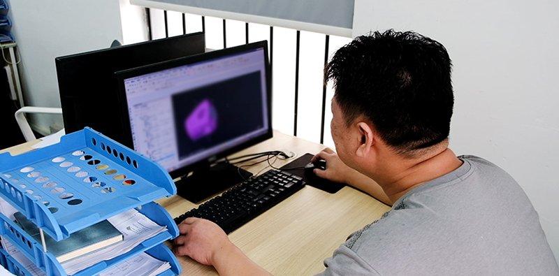 DFM review and quotation for custom precision machining, mechanical engineers analyzing manufacturability and project cost for CNC machined parts.
