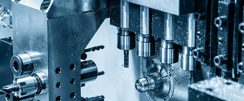 CNC machining process showing precision metal cutting on a CNC machine, removing material from workpiece to form custom mechanical parts.