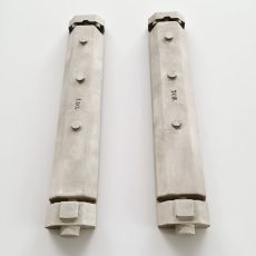 Sand casting process with molten metal pouring into molds, surrounded by machined components in a mechanical workshop