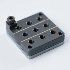 Precision machining of test fixture base structures for semiconductor auxiliary equipment, featuring high-tolerance cutting and surface finishing